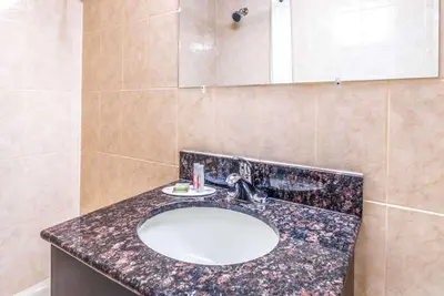 a bathroom with a sink and a mirror at Super 8 by Wyndham North Bergen NJ/NYC Area in North Bergen