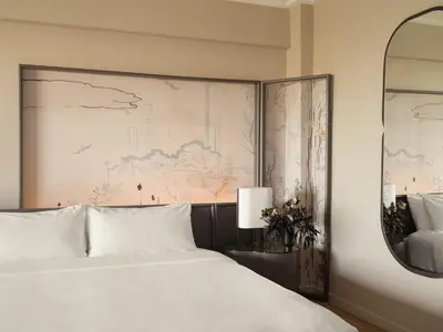 a bedroom with a large bed and a large painting at Park Lane New York in New York