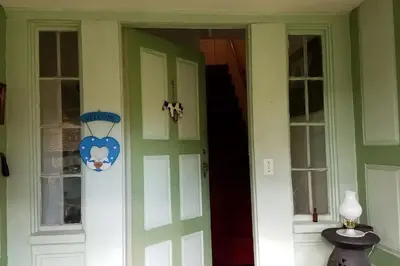 a green door of a house with a sign on it at The Open Door in Jefferson NY in Jefferson