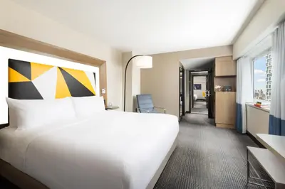 a hotel room with a large bed and a window at M Social Hotel New York Times Square in New York