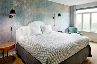 a hotel room with a bed and a chair at Tarrytown House Estate in Tarrytown
