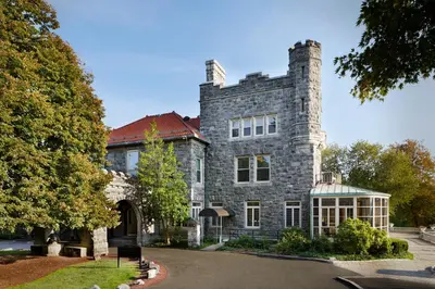 a large stone house with a chimney on top at Tarrytown House Estate in Tarrytown