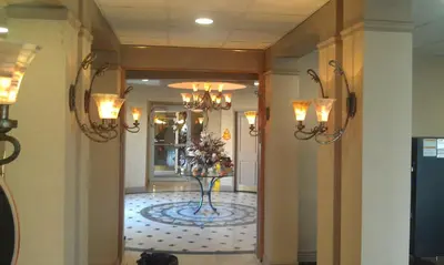 a hallway with a lobby with a vase of flowers at Howard Johnson by Wyndham Newburgh in Newburgh