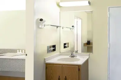 a bathroom with a sink and a mirror at Howard Johnson by Wyndham Newburgh in Newburgh