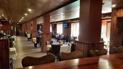 a dining room with tables and chairs in a restaurant at Skytop Lodge in Skytop
