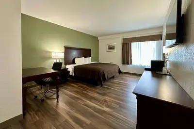 a hotel room with a bed and a desk at Quality Inn & Suites Albany Airport in Latham
