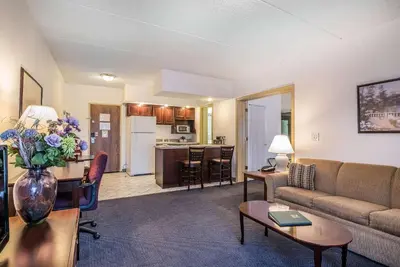 a living room with a couch and a table at Quality Inn & Suites Albany Airport in Latham