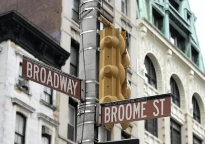 a traffic light and street signs on a pole at Solita Soho Hotel in New York