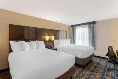 a hotel room with two beds and a window at Best Western Plus Fairfield Hotel in Fairfield