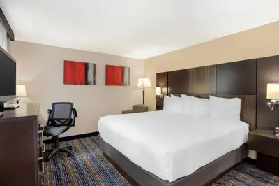 a hotel room with a large bed and a desk at Best Western Plus Fairfield Hotel in Fairfield