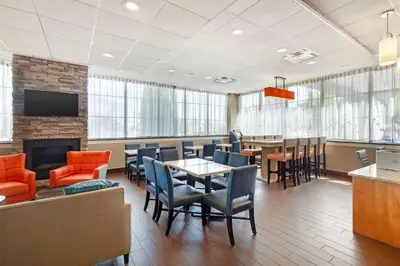 a waiting room with a table and chairs at Best Western Hartford Hotel and Suites in Hartford
