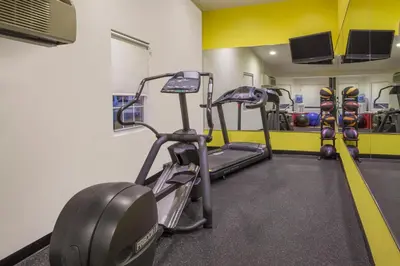 a gym with two tread machines in a room at Days Inn by Wyndham Woodbury Long Island in Woodbury