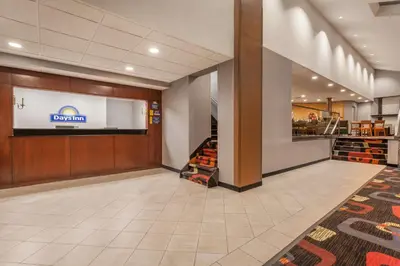 a lobby of a store with a sign on the wall at Days Inn by Wyndham Woodbury Long Island in Woodbury