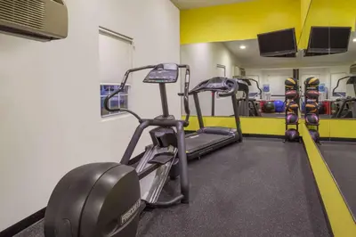 a gym with two tread machines in a room at Days Inn by Wyndham Woodbury Long Island in Woodbury