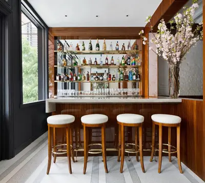 a bar with stools in a room with a window at 33 Hotel, New York City, Seaport in New York