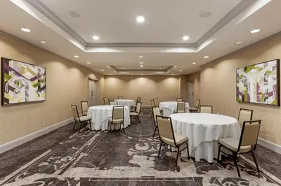 a conference room with tables and chairs and paintings at Omni New Haven Hotel at Yale in New Haven