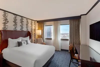 a hotel room with a bed and a window at Omni New Haven Hotel at Yale in New Haven