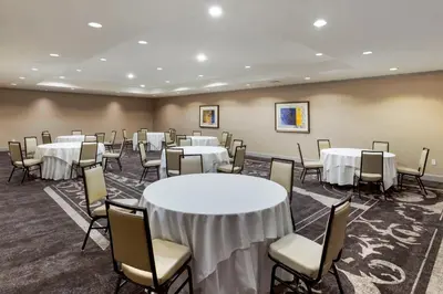 a room with tables and chairs in a room at Omni New Haven Hotel at Yale in New Haven