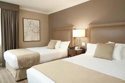 a hotel room with two beds and a telephone at Ethan Allen Hotel in Danbury
