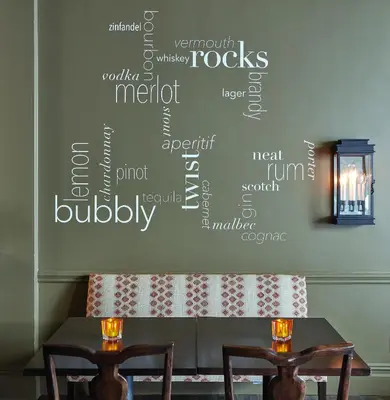 a table and two chairs with a wall with words on it at Ethan Allen Hotel in Danbury