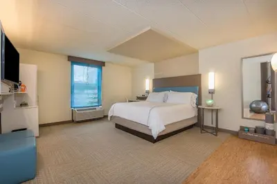a large bedroom with a bed and a television at EVEN Hotel Norwalk by IHG in Norwalk