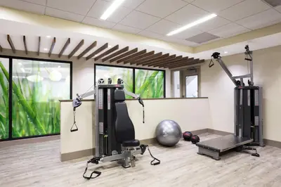a gym with two tread machines and a fitness ball at EVEN Hotel Norwalk by IHG in Norwalk