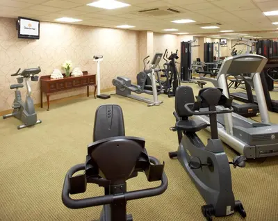 a gym with treadmills and elliptical machines at Clinton Inn Hotel Tenafly in Tenafly