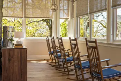 a row of chairs in a room with windows at The Abbey Inn & Spa in Peekskill