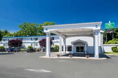 a gas station in front of a building at Quality Inn & Suites Danbury near University in Danbury