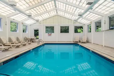 an indoor pool with a skylight and a pool house at Quality Inn & Suites Danbury near University in Danbury
