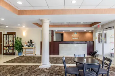 a meeting room with a table and chairs in a lobby at Quality Inn & Suites Danbury near University in Danbury