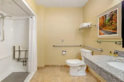 a bathroom with a toilet and a sink at Best Western Plus New England Inn & Suites in Berlin