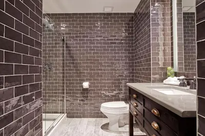 a bathroom with a toilet and a glass shower at Ravel Hotel Trademark Collection by Wyndham in Queens