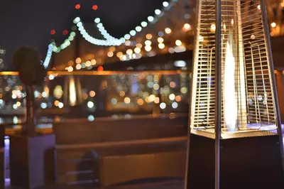 a bench in front of a window with lights at Ravel Hotel Trademark Collection by Wyndham in Queens