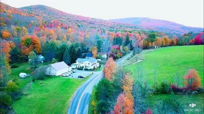 an aerial view of a farm with a road and trees at Mountain Treasure Bed and Breakfast in Maplecrest