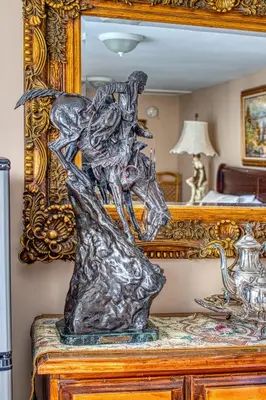 a sculpture on a dresser in front of a mirror at Mountain Treasure Bed and Breakfast in Maplecrest