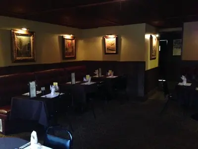 a dining room with tables and chairs in a restaurant at Fred's Inn Restaurant & Lodging in Norwich
