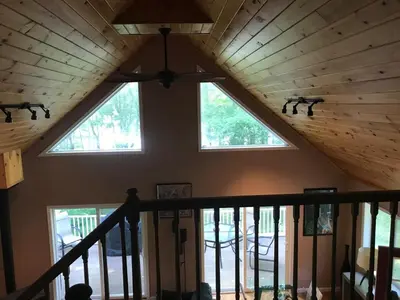 a ceiling in a house with two windows at Hidden Lakefront Retreat in Sherburne