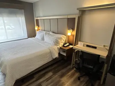 a hotel room with a bed and a desk and a window at Best Western Roslyn-Long Island Hotel in Roslyn
