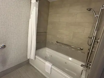 a bathroom with a bath tub with a shower curtain at Best Western Roslyn-Long Island Hotel in Roslyn
