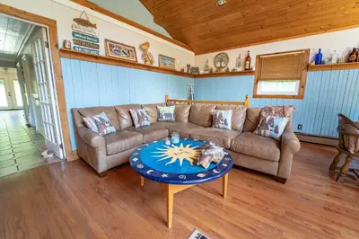 a living room with a couch and a table at Roscoe Cabin Pet friendly in Roscoe
