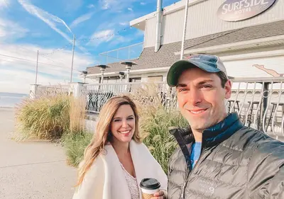 a man and a woman standing in front of a building at The Surfside Hotel in Stratford