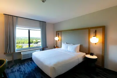a hotel room with a large bed and a large window at Fairfield Inn & Suites Scranton Montage Mountain in Moosic