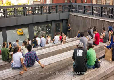 a group of people sitting on the steps of a building at UPDATED Amazing Bi -Level Condo minutes from water views of New York City in North Bergen