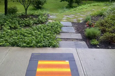 a garden with a colorful rug on a sidewalk at Contemporary 3 Bedroom Apt with Sauna in Woods in Armonk