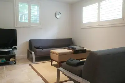 a living room with a couch and a tv at Contemporary 3 Bedroom Apt with Sauna in Woods in Armonk