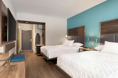 a hotel room with two beds and a bathroom at Tru By Hilton Albany Airport, Ny in Latham