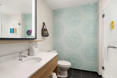 a bathroom with a sink and a toilet at Tru By Hilton Albany Airport, Ny in Latham