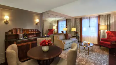 a living room with a couch and a table at InterContinental New York Barclay Hotel by IHG in New York