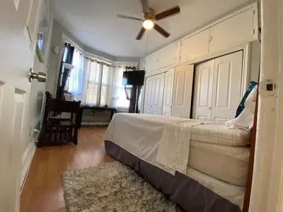 a bedroom with a bed and a ceiling fan at Cozy apt in WEST NY, NEW JERSEY, at 2 bloks from bus stop-15 minutes 2NY 7MINUTES VIA NYWATERWAY FERRY-BETTER CAN'T BE!! in West New York
